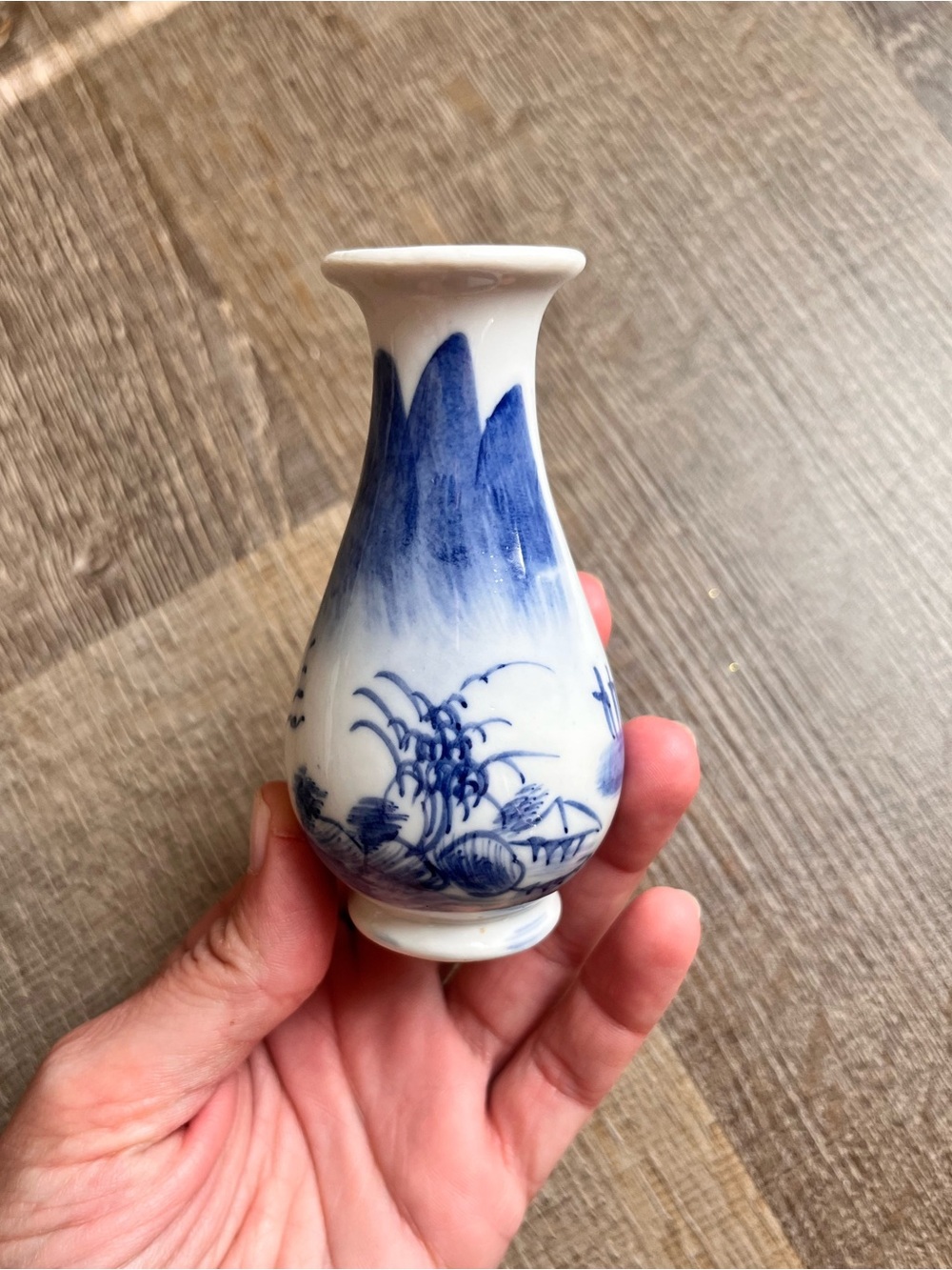 Chinese style porcelain bud vase with a flared rim and hand-painted landscape